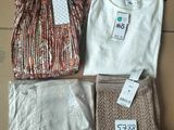 three pieces of clothing sitting on a cardboard box