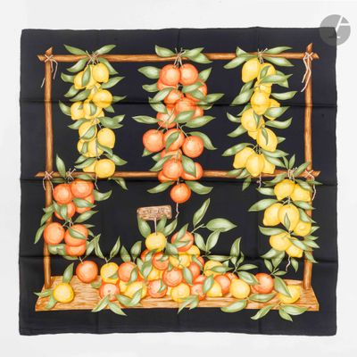 a close up of a black square scarf with oranges and leaves