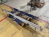 a pile of ski poles sitting on a pallet in a garage