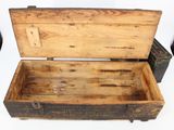 an old wooden box with a metal latch on it