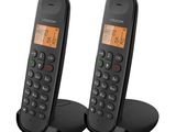 a pair of black corded phones sitting on top of each other