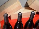 several bottles of wine are lined up on a table