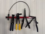 many tools hanging on the wall next to each other