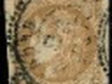 a close up of a stamp with a face on it