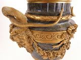a gold and black vase with a snake on it