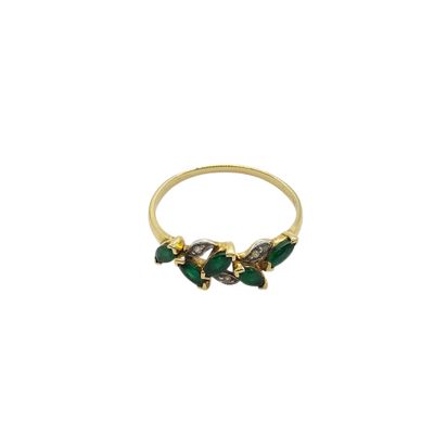 a close up of a gold ring with green and white stones