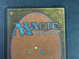 the back of a magic the gathering card with a picture of a face on it
