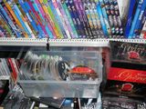 many dvds and dvds on the shelves in the store