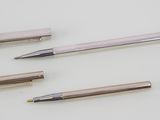 three different types of pens and pencils on a white surface