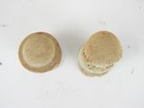 two cookies that are sitting on a white surface
