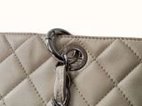 a white purse with a chain hanging from it ' s side