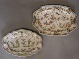 Deux assiettes ornées d'un motif sont posées sur une table.