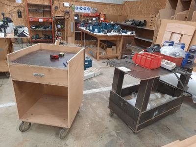 two tables with tools on them in a workshop