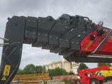 a red crane that is sitting on top of a truck