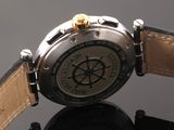 a close up of a watch on a black surface