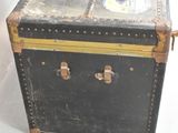 an old suitcase sitting on a white surface