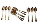 several spoons and spoon spoons are lined up on a white surface