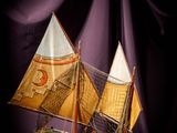 a small model of a sailboat on a table
