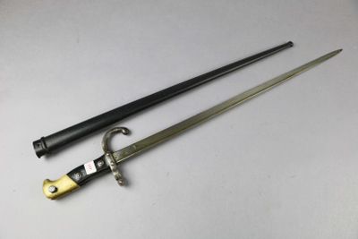 a close up of two swords on a white surface