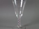 a wine glass that has a spiral design on it