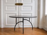 une table noire avec un plateau noir dans une pièce blanche