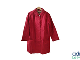 red coat hanging on a hanger on a white background