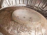 a silver bowl sitting on top of a table