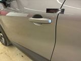 a close up of a car door handle with a sticker on it