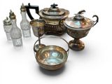 a lot of silver and glass items on a white surface