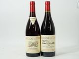 two bottles of red wine sitting next to each other on a white surface