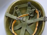 a green helmet with a yellow strap on it