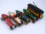 a lot of toy cars and a bus on a white surface