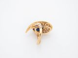 a close up of a gold ring with a blue stone