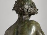 a bronze statue of a man holding a bird in his hand