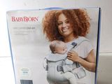 the box of the baby born carrier is open on the table