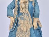 a doll that is wearing a blue dress and hat