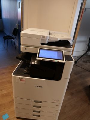 a white printer sitting on top of a wooden floor