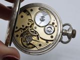 a close up of a pocket watch being held by a person