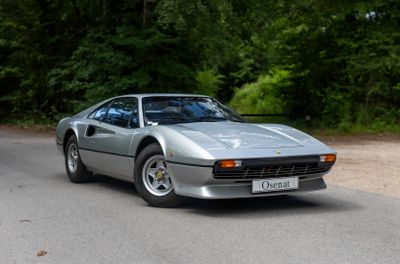 a silver sports car parked on the side of the road