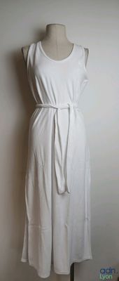a white dress that is on a mannequin stand