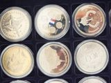 several different coins are in a black box on a table