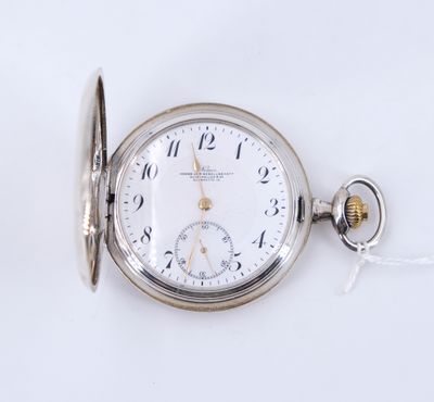 une vieille montre de poche à laquelle est accrochée une chaîne sur le côté