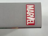 someone is holding a book with the word marvel on it