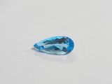 a close up of a blue topaz stone on a white surface