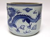 a blue and white vase with a dragon on it