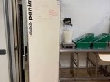 un grand réfrigérateur blanc dans une pièce dotée de nombreux plans de travail