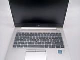 an open laptop computer sitting on top of a white table