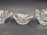 three glass vases sitting on top of a table next to each other