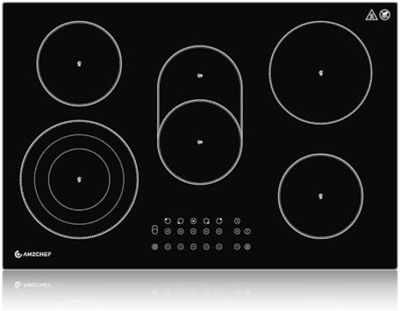gros plan d'une cuisinière noire à quatre brûleurs