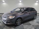 the grey citrole is parked on a checkered tile floor